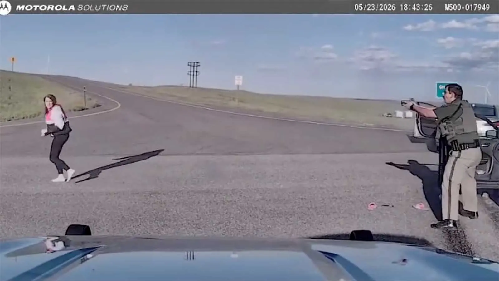 Dashcam video released Thursday shows the wild end to a 120 mph Wyoming interstate where a woman was struck by her own moving car as she bailed out and ran on foot. Even with two flat tires, she was still driving more than 100 mph, officials report.