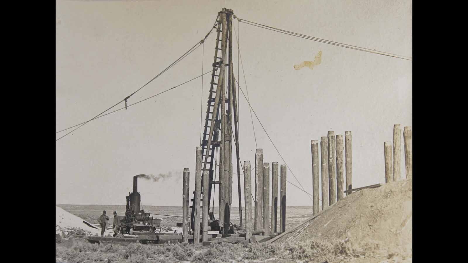 A steam-powered pile driver used in bridge construction and repair, between Casper and Shoshoni, 1906.