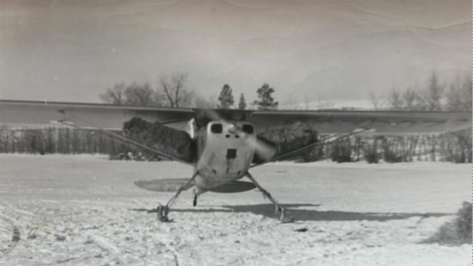 Prior to the formal establishment of the current elk feed ground system, Jim Harrower, with pilot Roland Barry, would feed elk from the air using this airplane. Note the bales attached to each wing that Jim and Roland would cut open during flight.