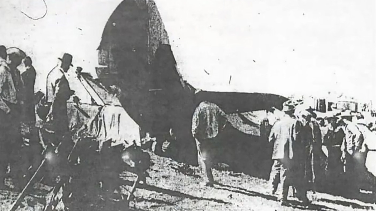 People gather around the wreckage of a crash that killed 12 people in 1935.