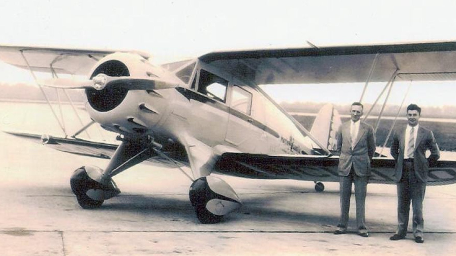 Owner Lynn Burnside Smith and pilot Richard (Dick) Arnett pose with the Aero Mayflower Transit Company plane that crashed into Laramie Peak in August 1935.