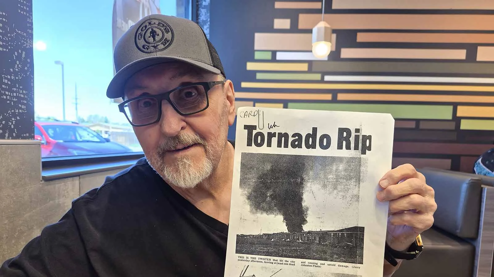 Jerry Johnston of Cheyenne holds up a copy of the photo (top) that he took of the tornado that hit the capital city on July 1, 1979.