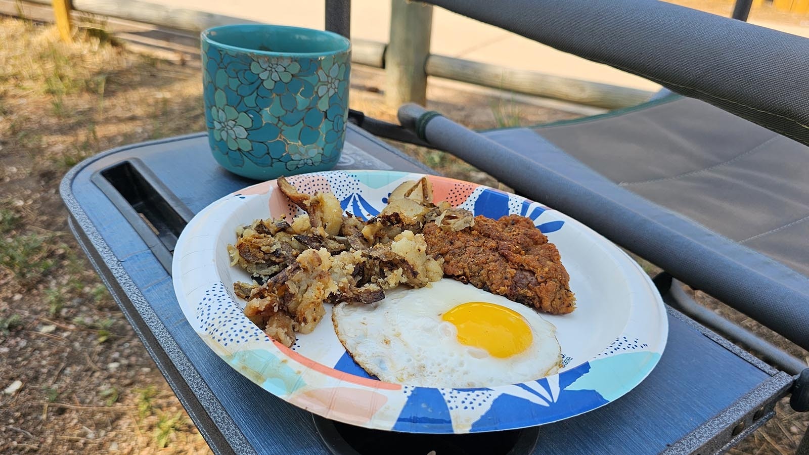 A perfect chuckwagon breakfast. Fried potatoes, chicken-fried steak and an egg, sunny side up.