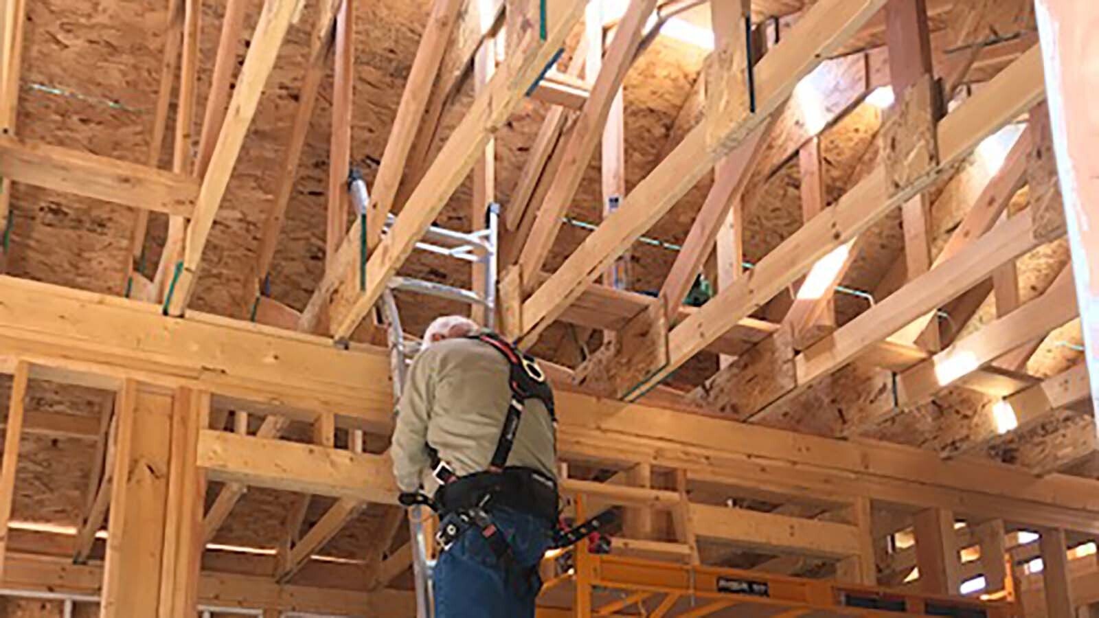 Larry Ash works on chimney preparation for his cabin.