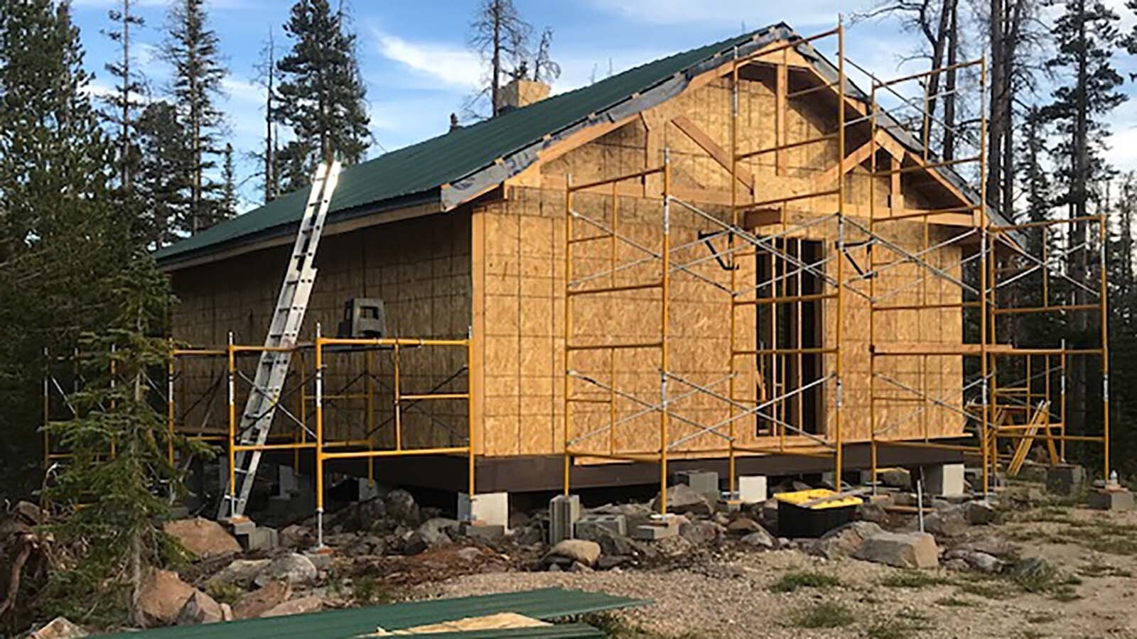 Larry Ash and Dave Simpson were able to go from just a foundation and floor to walls and roof during their second season of building Larry’s cabin.