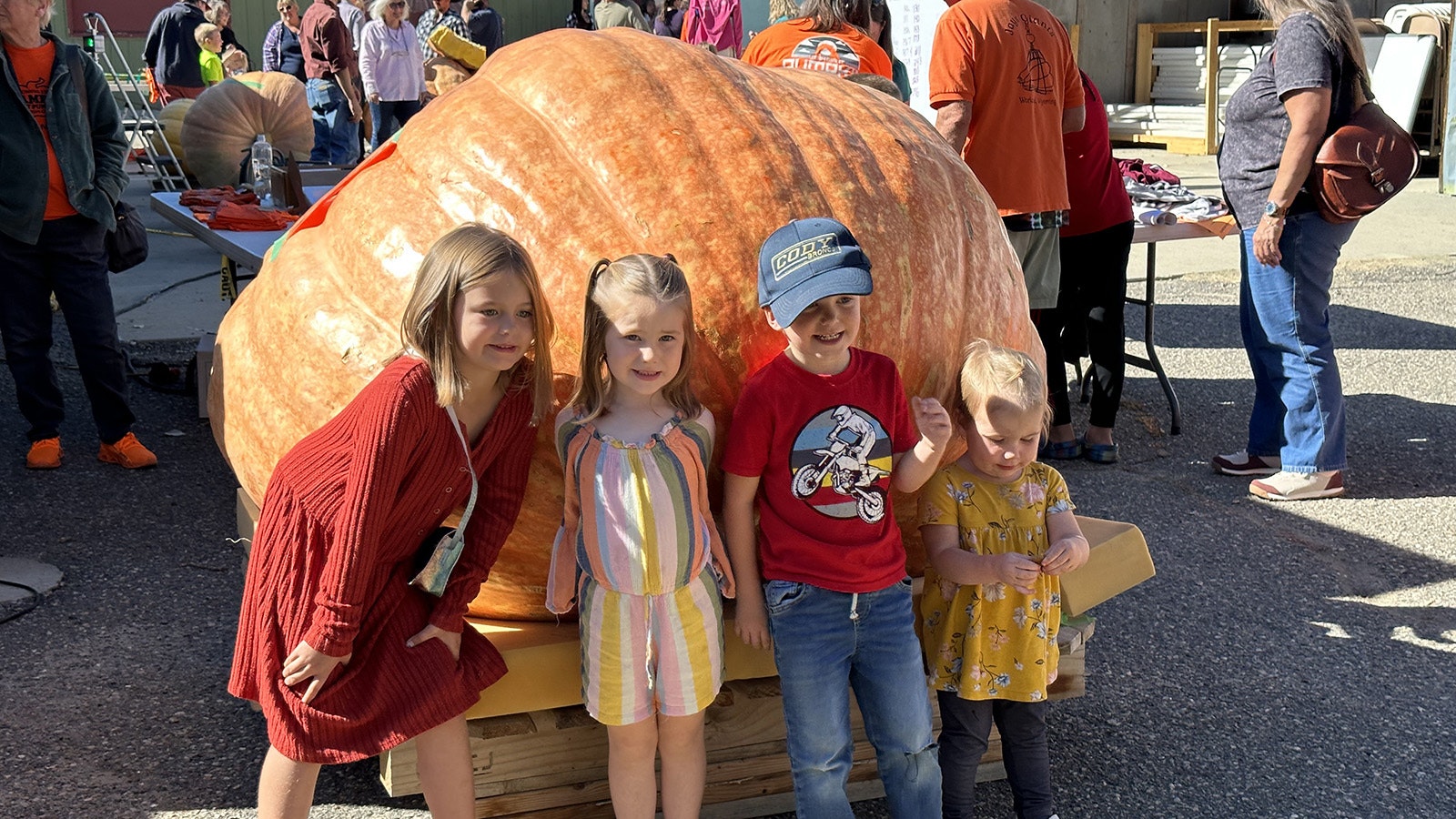 Four kids and a pumpkin.
