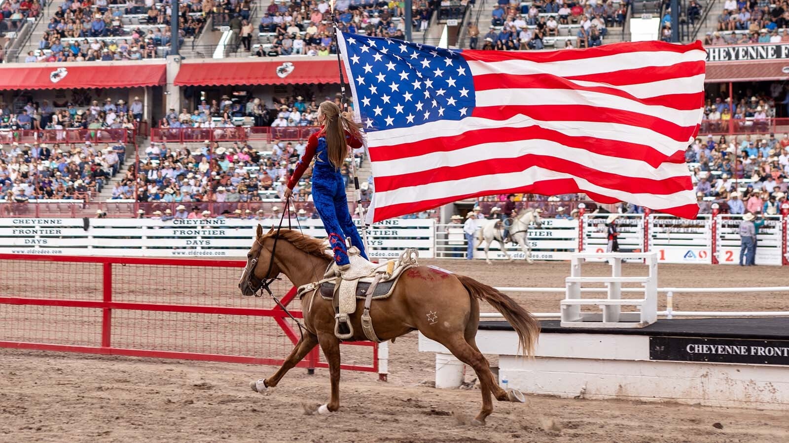 The American flag is taken around the arena during the Grand Entrance at the 2024 Cheyenne Frontier Days.