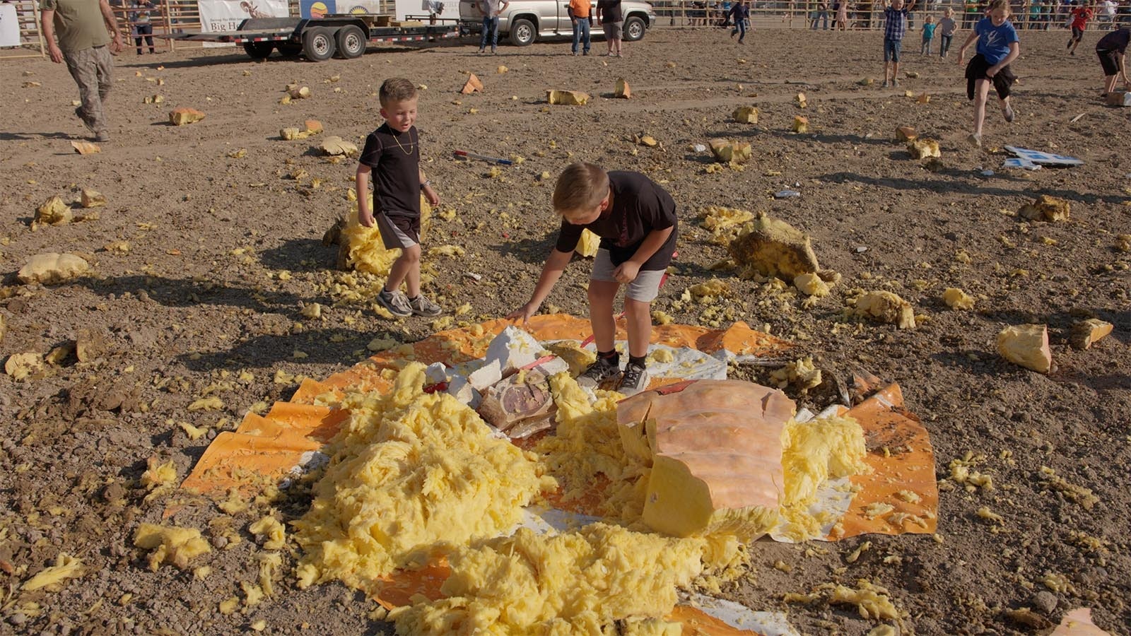 Children survey the damage after a giant pumpkin impacted a cutout of Wile E. Coyote on Oct. 5, 2024.