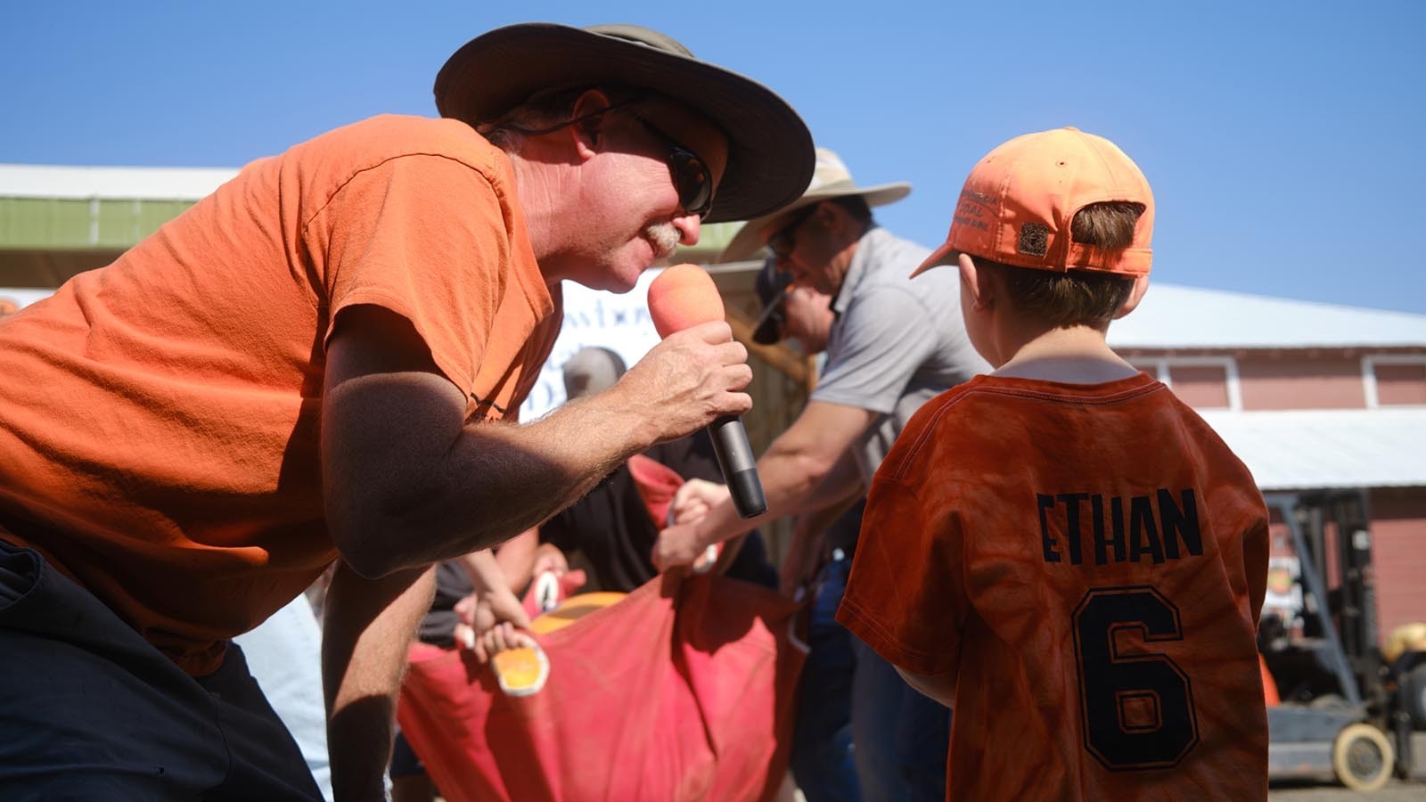 Event organizer Jay Richard talks with Ethan Mills, 6, as they wait to see how much the child's pumpkin weighs on Oct. 5, 2024 at the Wyoming State Pumpkin Weigh-Off.