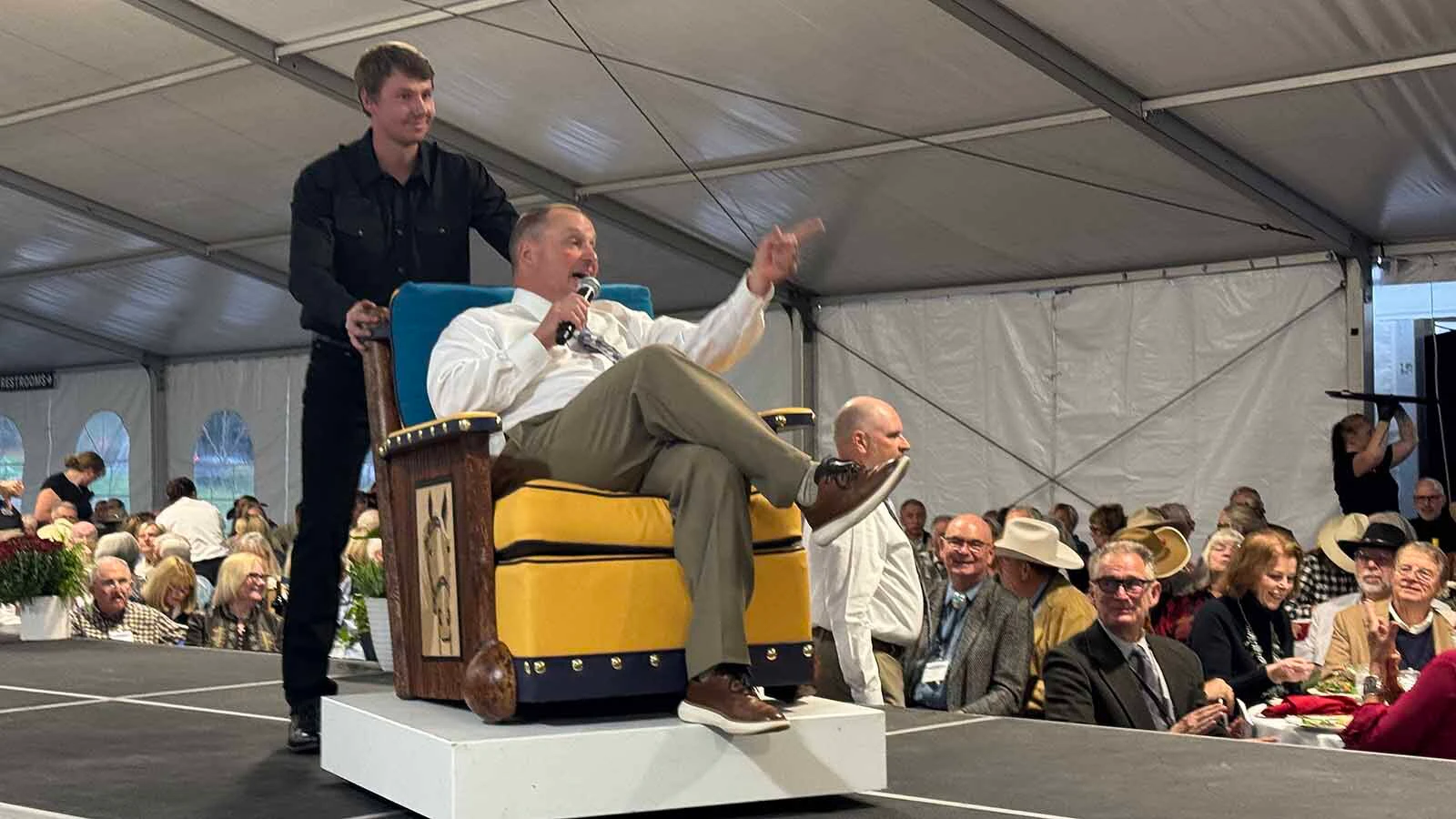 Auctioneer Troy Black enjoys a ride in a Chimayo Club Chair by Ian Gallis during the 45th Buffalo Bill Art Show and Sale in Cody.