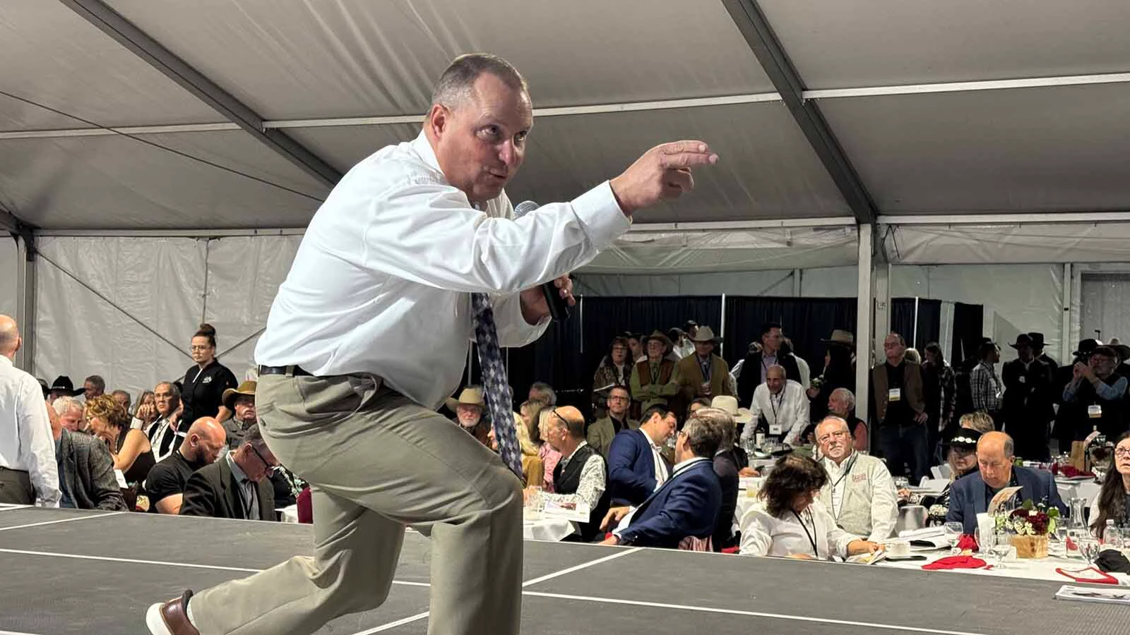 Auctioneer Troy Black keeps bids coming in, despite a city-wide power outage, during the 45th Buffalo Bill Art Show and Sale on Friday. 