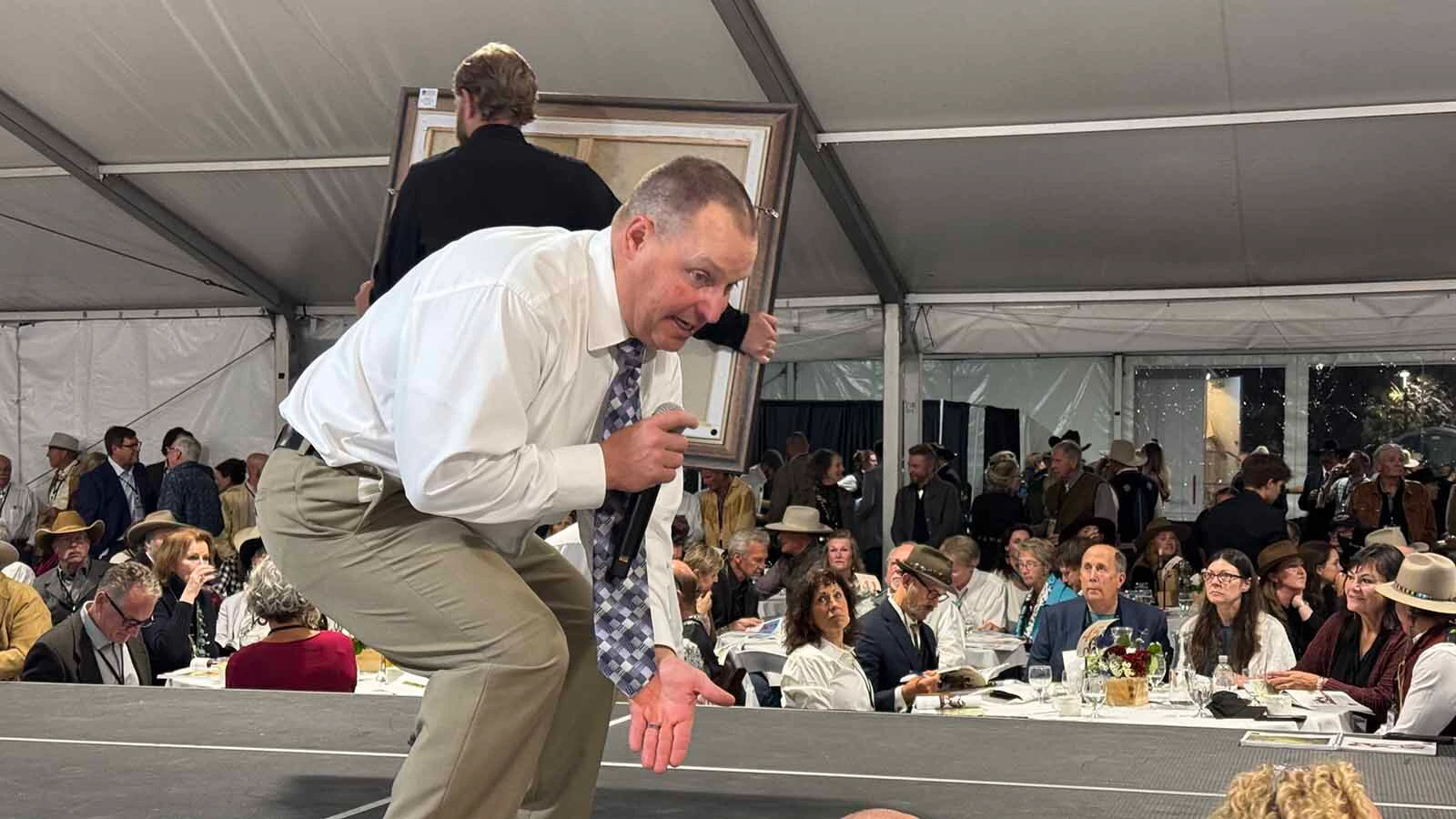 Auctioneer Troy Black keeps bids coming in, despite a city-wide power outage, during the 45th Buffalo Bill Art Show and Sale on Friday. 