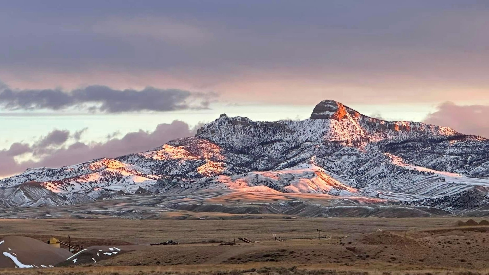 "Beautiful sunrise reflected on Heart Mountain and through Skull Creek north of Cody this morning."