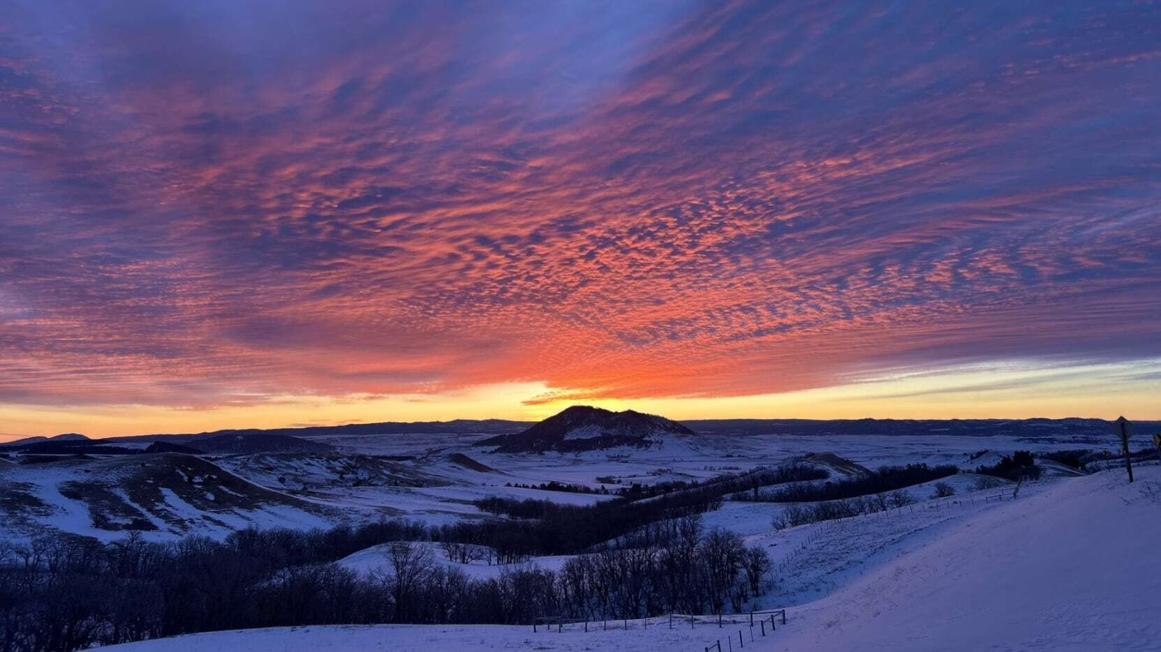 "WYDOT District 4 Sundance area foreman, Rusty Speidel, caught this sunrise during his early morning road check. This was taken from US 14 west of Sundance near Rupp Hill."