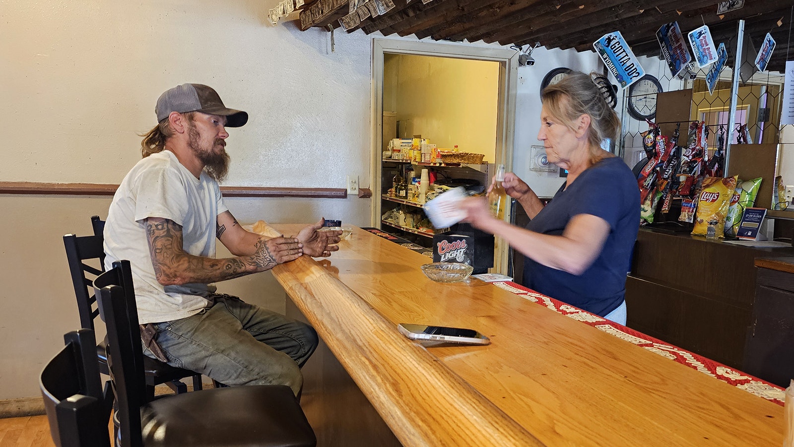 Shirley Bullock serves a customer at 3 Sisters Truck Stop in Manville, Wyoming.