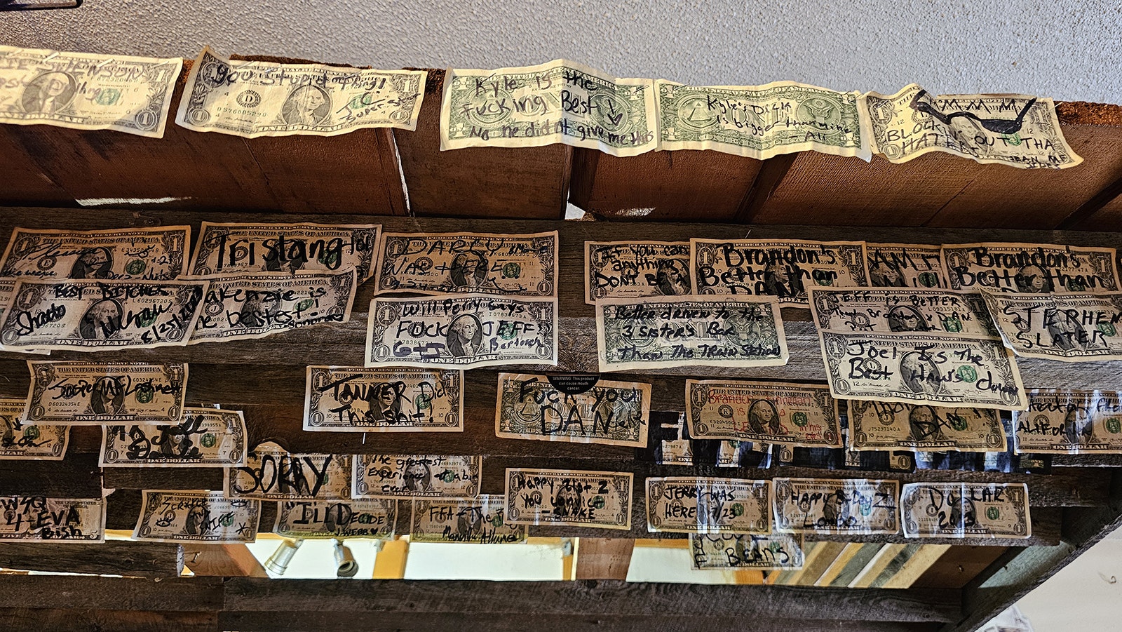 Over the years, customers have decorated the roof of the bar with signed dollar bills. No one knows how it started, but some of the messages are funny.