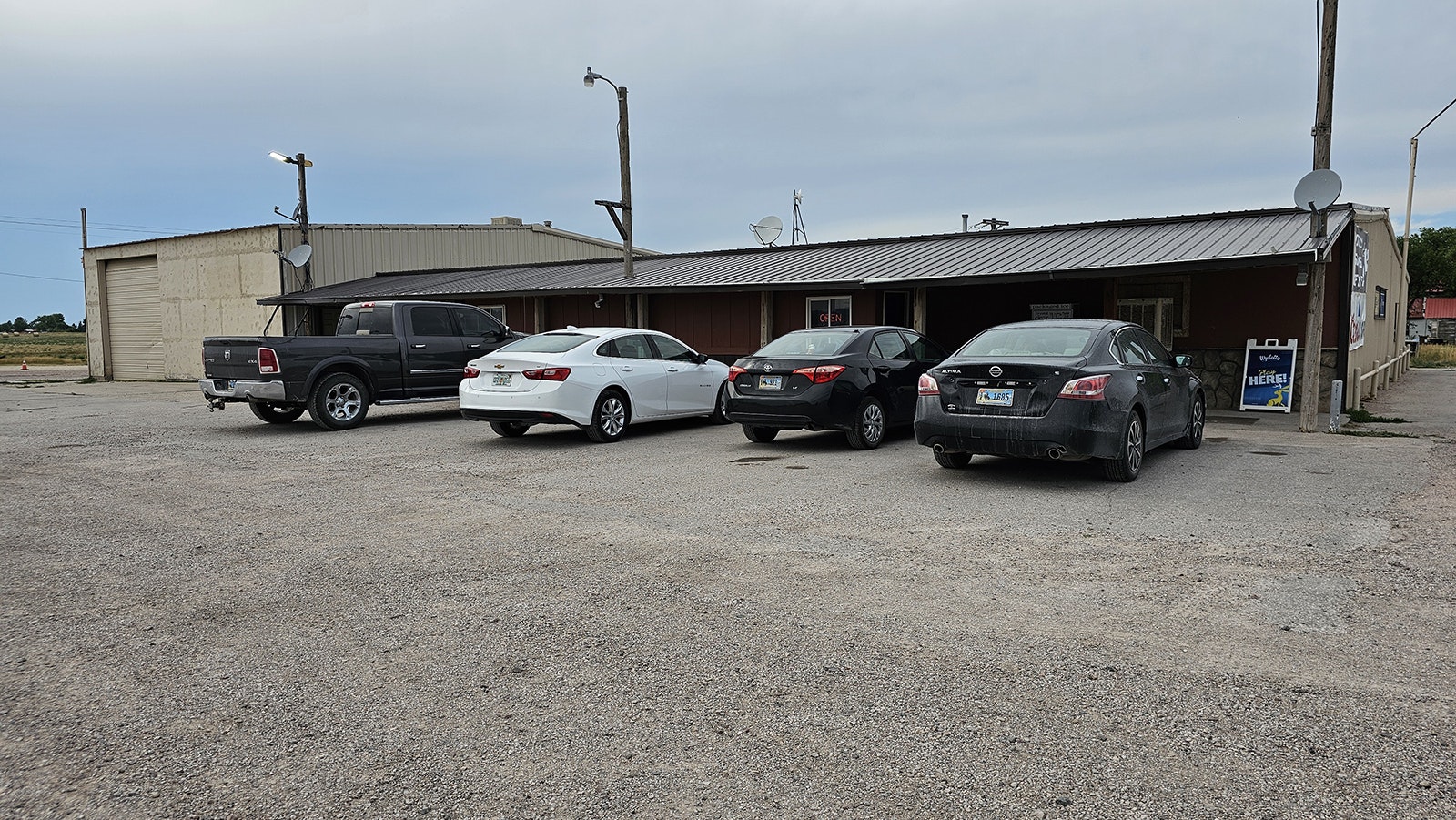 Cars parked outside the 3 Sisters Truck Stop in Manville, Wyoming.