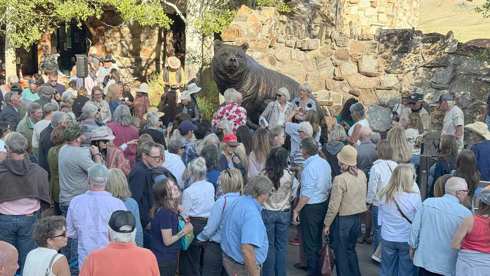 "The last 399 jam" forms around "Against All Odds: Grizzly 399," a bronze sculpture of Grizzly 399 and "the quads" at the National Museum of Wildlife Art in Jackson.