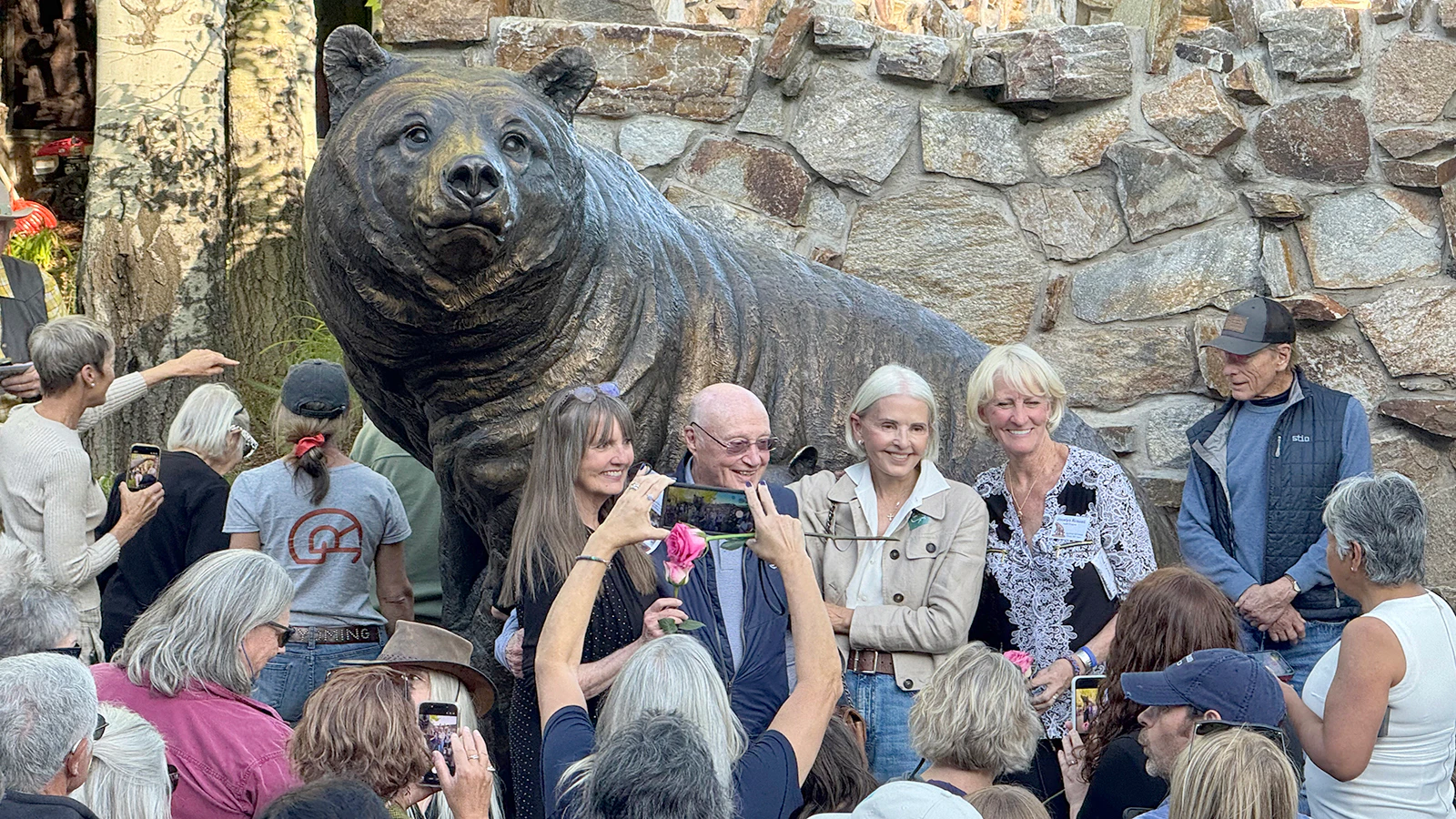 A group poses next to a larger-than-life bronze sculpture of Grizzly 399 at the National Museum of Wildlife Art in Jackson on Wednesday evening.