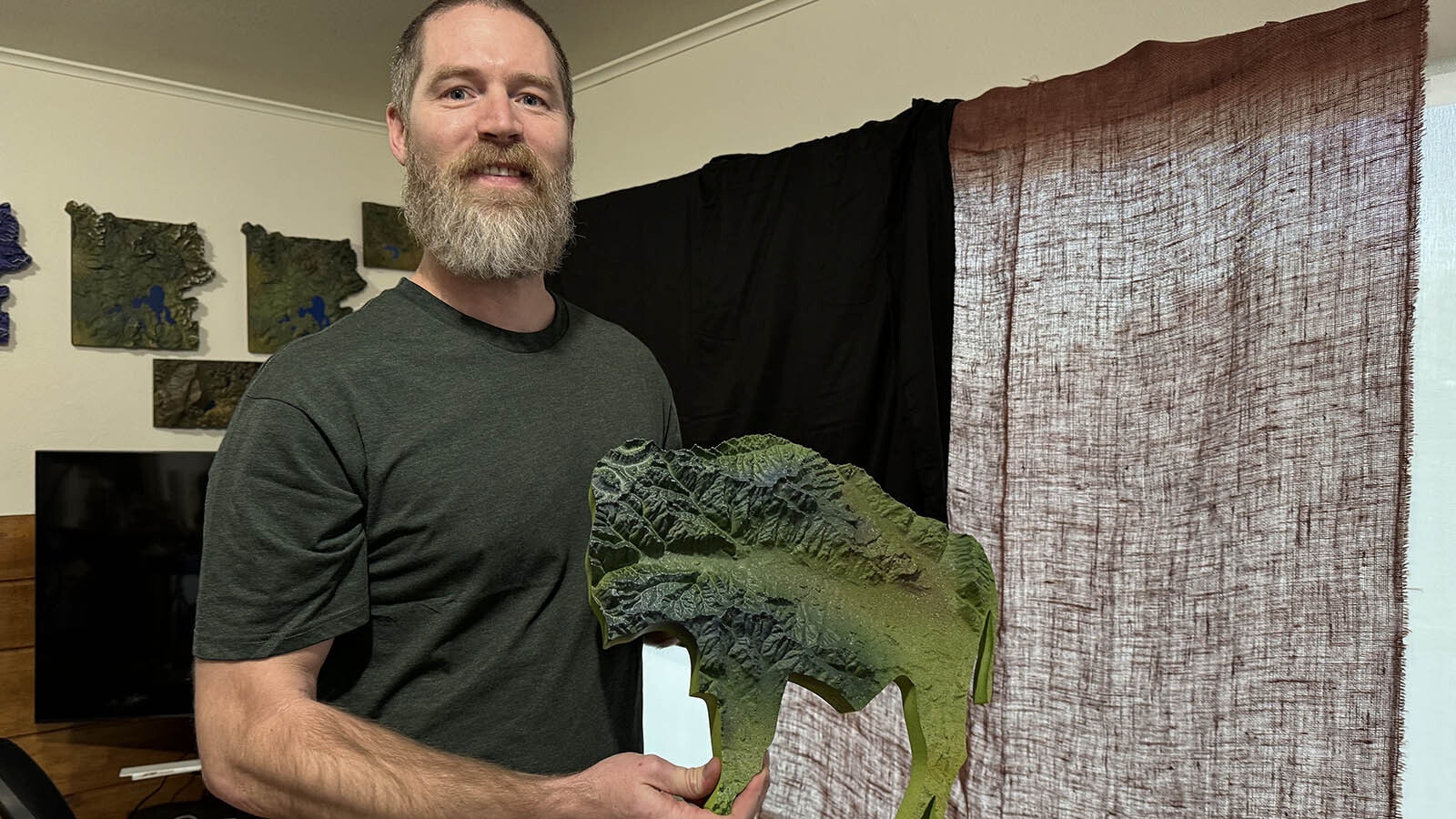 Nicholas Resch with a 3D-printed map of the South Fork of the Shoshone River, printed in the shape of the Wyoming bison. Maps like these are his best-selling 3D printing projects.