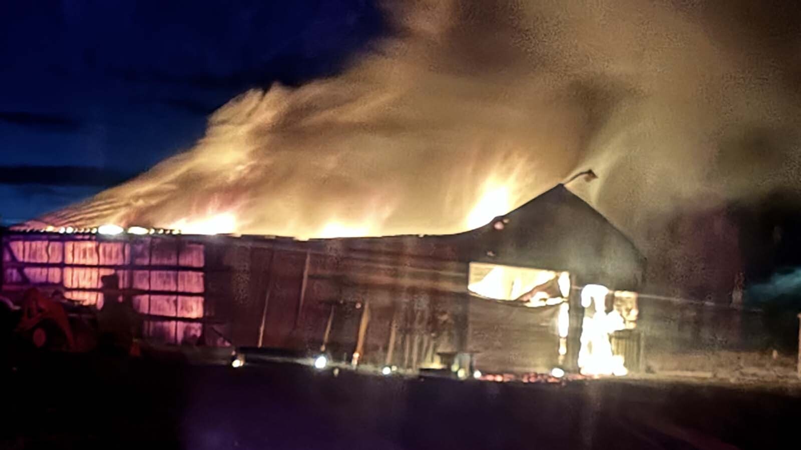 Flames engulf the Wulf family’s shop on Saturday.