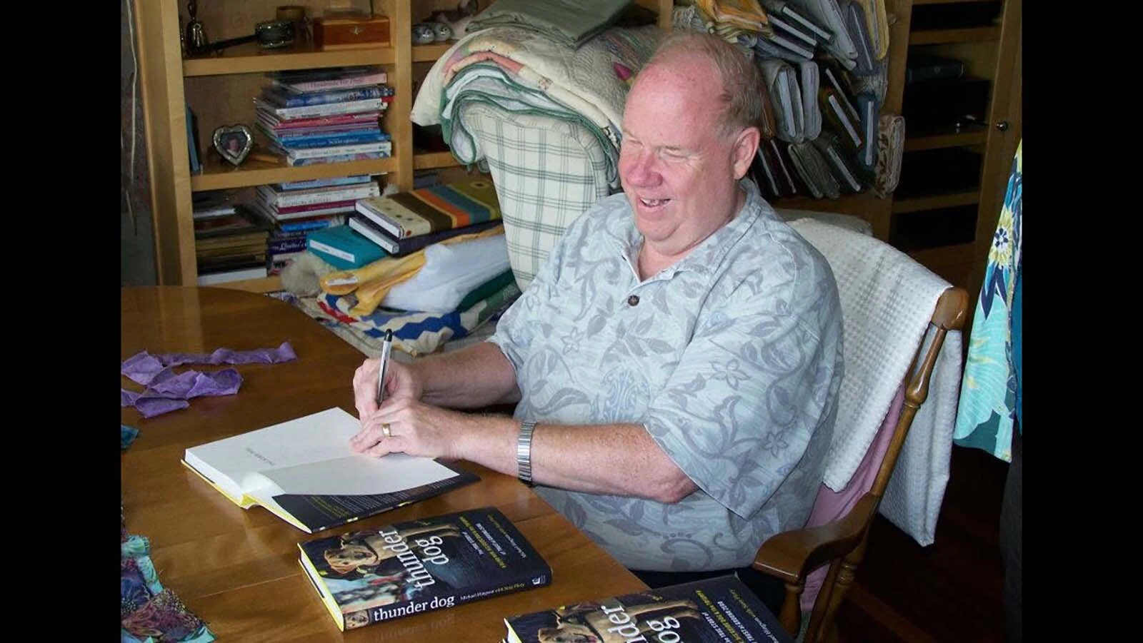 Michael Hingson signs copies of his book "Thunder Dog," about his former guide dog Rosalie, who helped him navigate the stairs down 78 floors of a crumbling World Trade Center North Tower on Sept. 11, 2001.