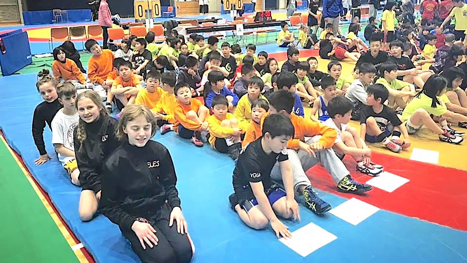 A 10-year-old Tai Mc Bride, last in near row, takes part in wrestling seminar in Japan.