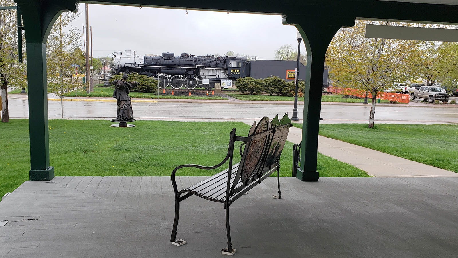 A bench looks out on the rest of Sheridan and a nearby locomotive.