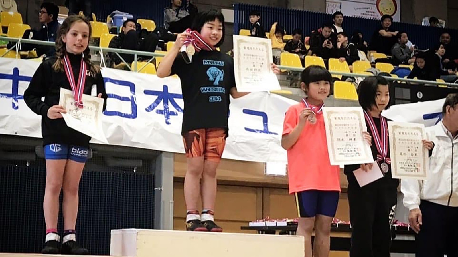 A tiny Tai McBride on the podium of a tournament in Japan.