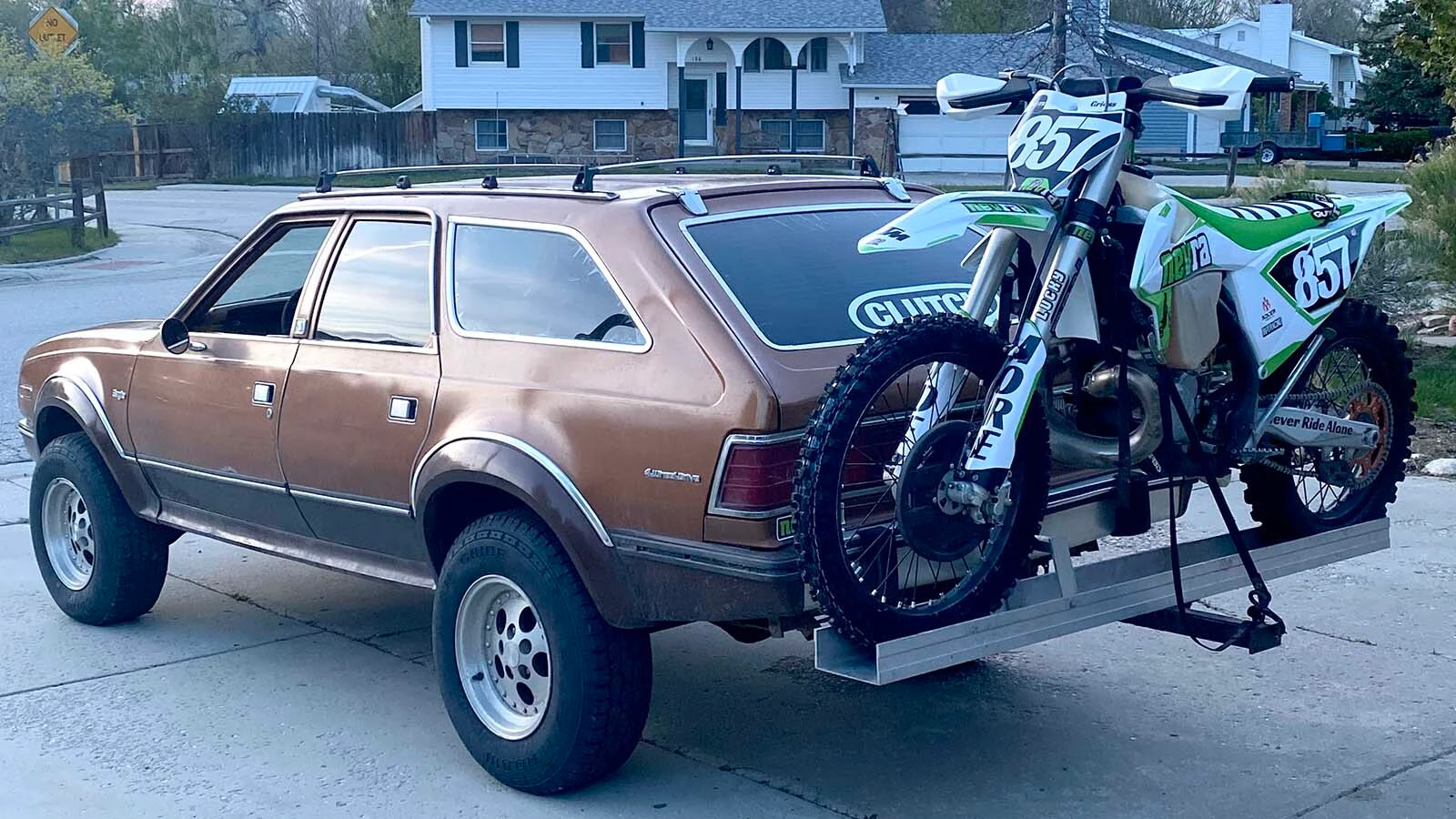 A dirt bike rides shotgun on the back of Austin Griess' lifted 1984 AMC Eagle.