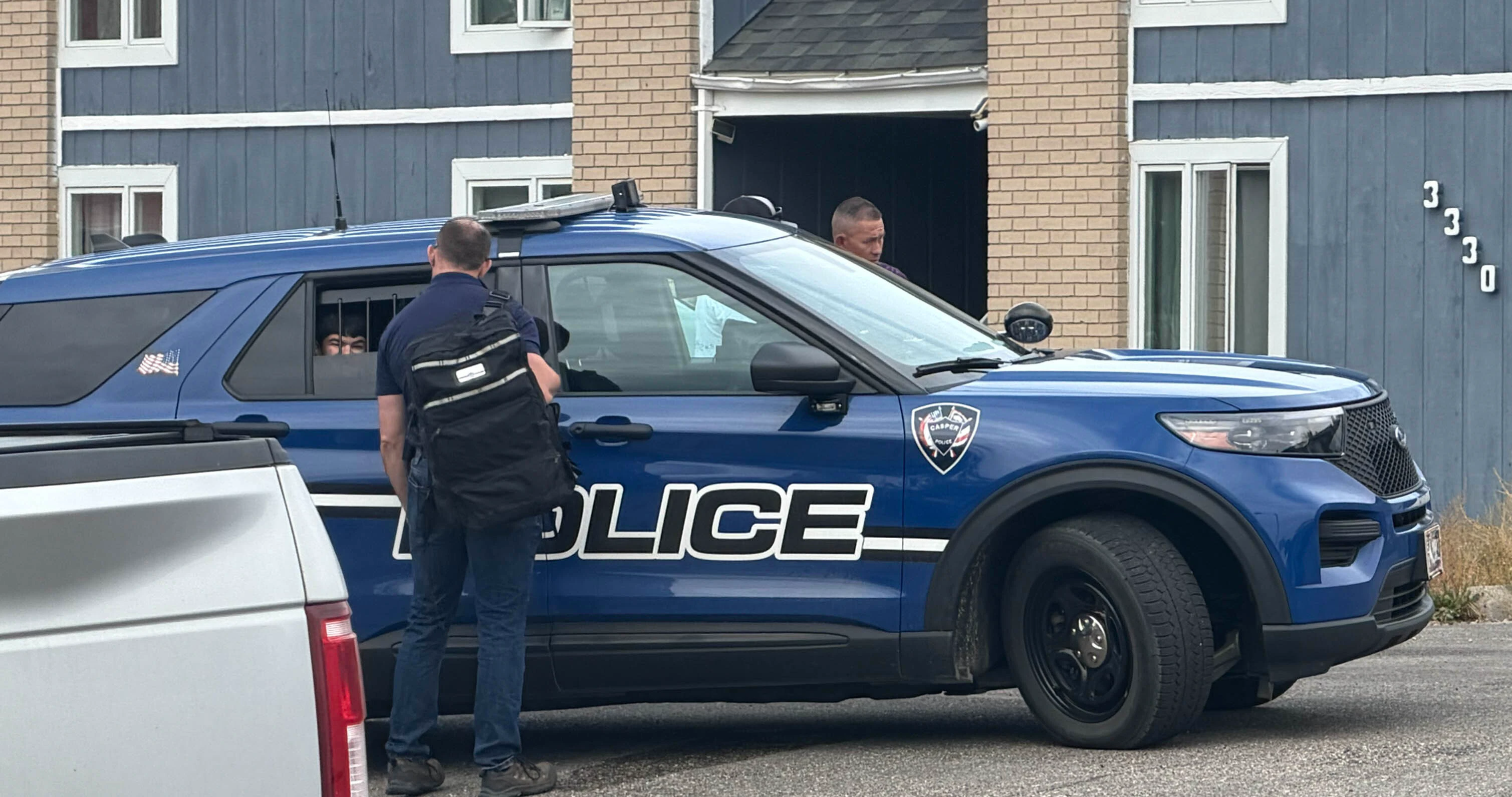 A person sits in the back of a Casper police SUV on Provence Court on Friday, Sept. 25, 2026, during an ATF search warrant operation.