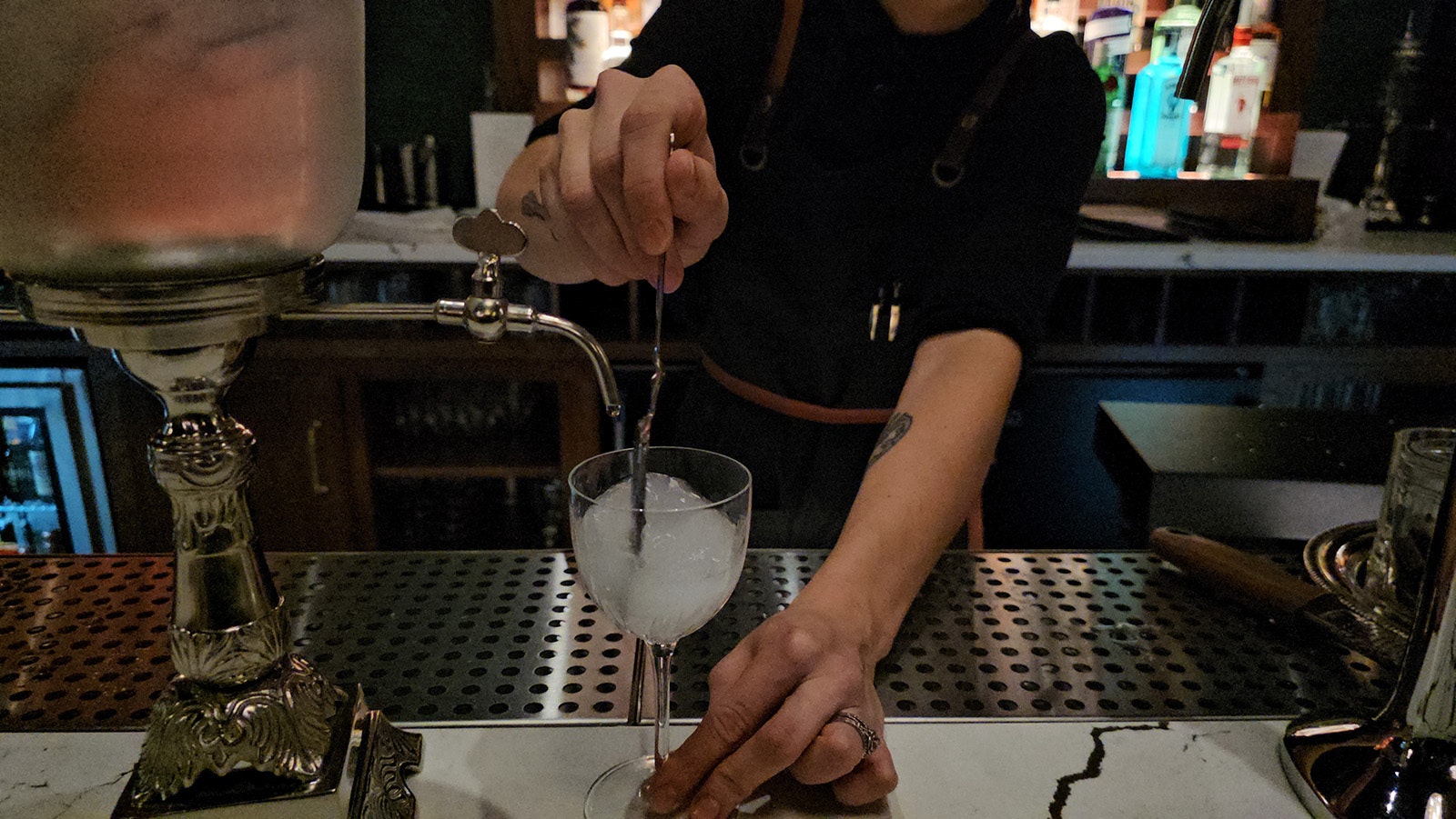 Once the sugar has dissolved, the bartender gives it a stir and serves the glass.