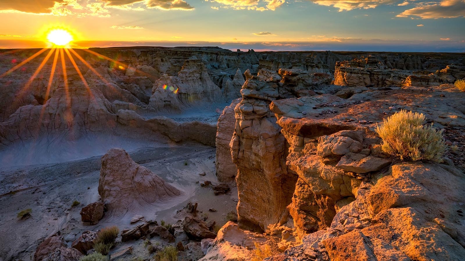 The sun peeks over the horizon over Adobe Town in Wyoming's Red Desert.