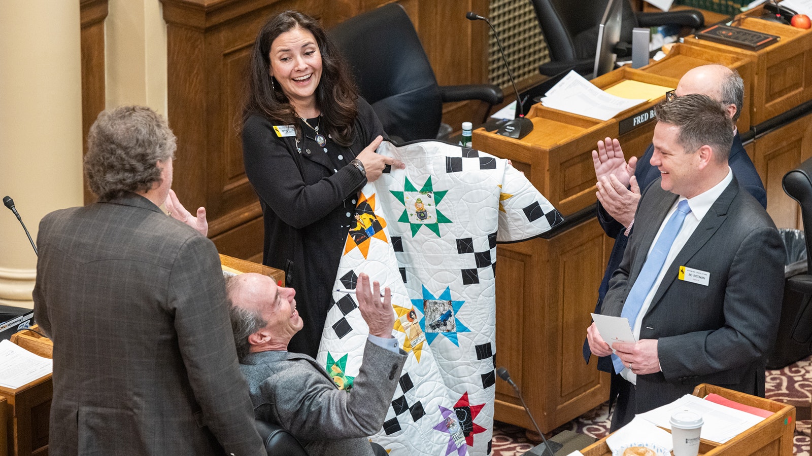 State Sen. Affie Ellis with a quilt she made with individualized squares for each of the 31 members of the Wyoming Senate.