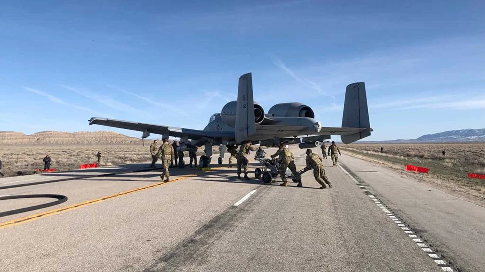 Members of the 127th Maintenance Group's "ACE" team, conduct integrated combat turns on an A-10 Thunderbolt II aircraft on a Wyoming highway as part of Exercise Agile Chariot, Apr. 30, 2023. The Selfridge Air National Guard-based team of Citizen-Airmen were invited by AFSOC to participate in exercise Agile Chariot, a training event that was historical, in part, due to the number and type of aircraft involved. The ACE team supported landings and takeoffs of the MC-130J, MQ-9 Reaper and two of their own A-10 Thunderbolt II aircraft on Wyoming Highway 287.