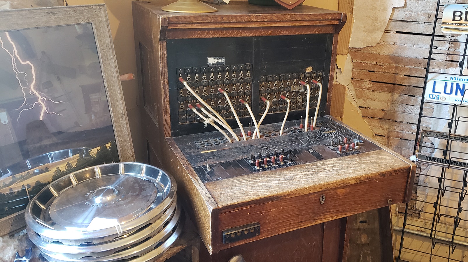 An old switchboard upstairs in the Aladdin General Store sandwiched between hubcaps, licenses plates and a print of lightning striking near Devils Tower.