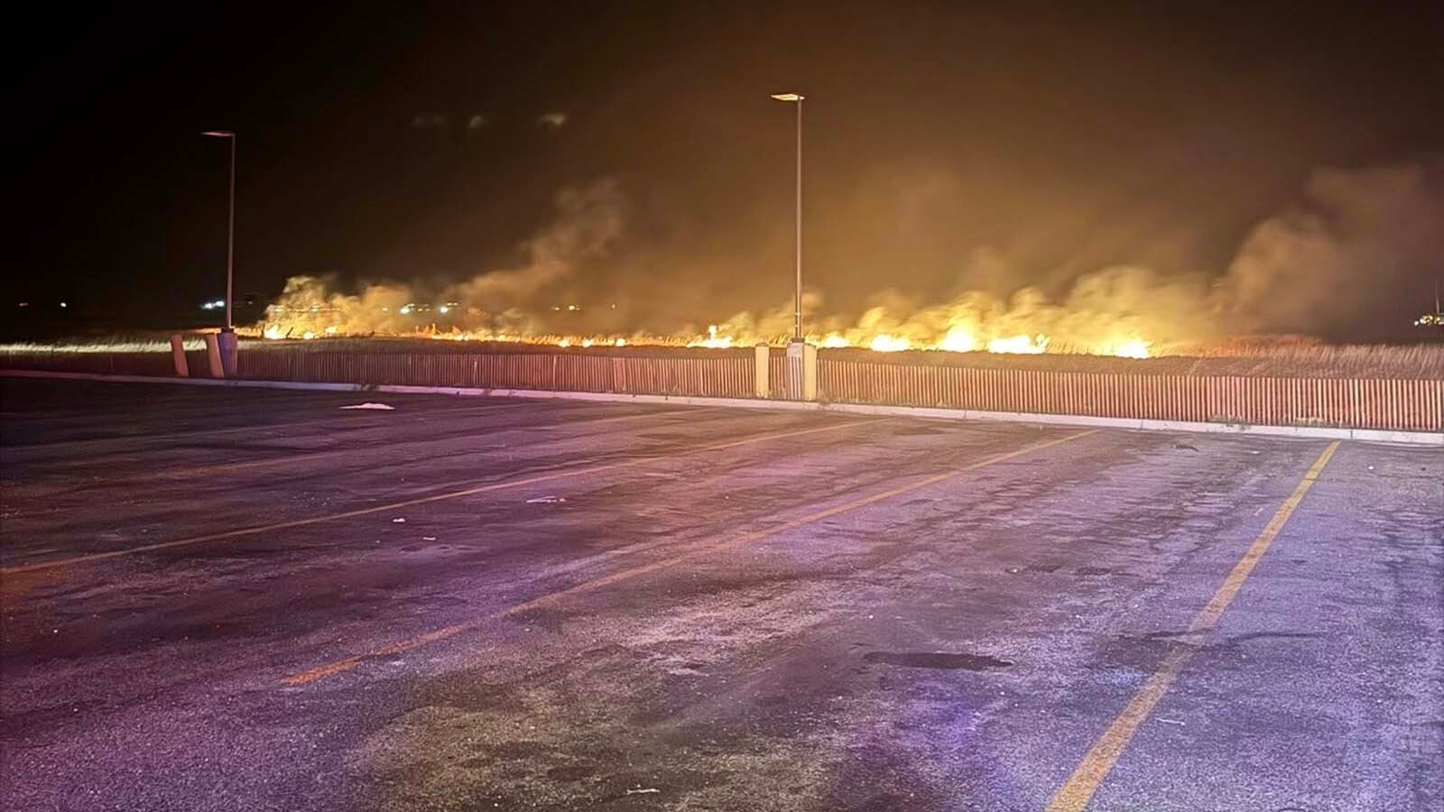 A 56-acre grass fire that ignited near multiple Laramie gas stations Monday is believed to have originated from I-80, officials believe. Fire crews are now watching the area to ensure the blaze does not rekindle. 