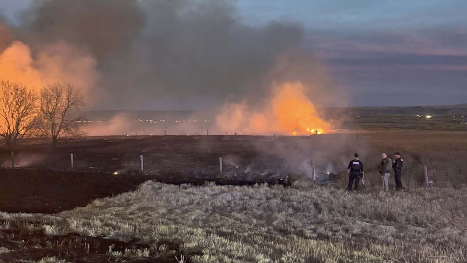 A 56-acre grass fire that ignited near multiple Laramie gas stations Monday is believed to have originated from I-80, officials believe. Fire crews are now watching the area to ensure the blaze does not rekindle. 