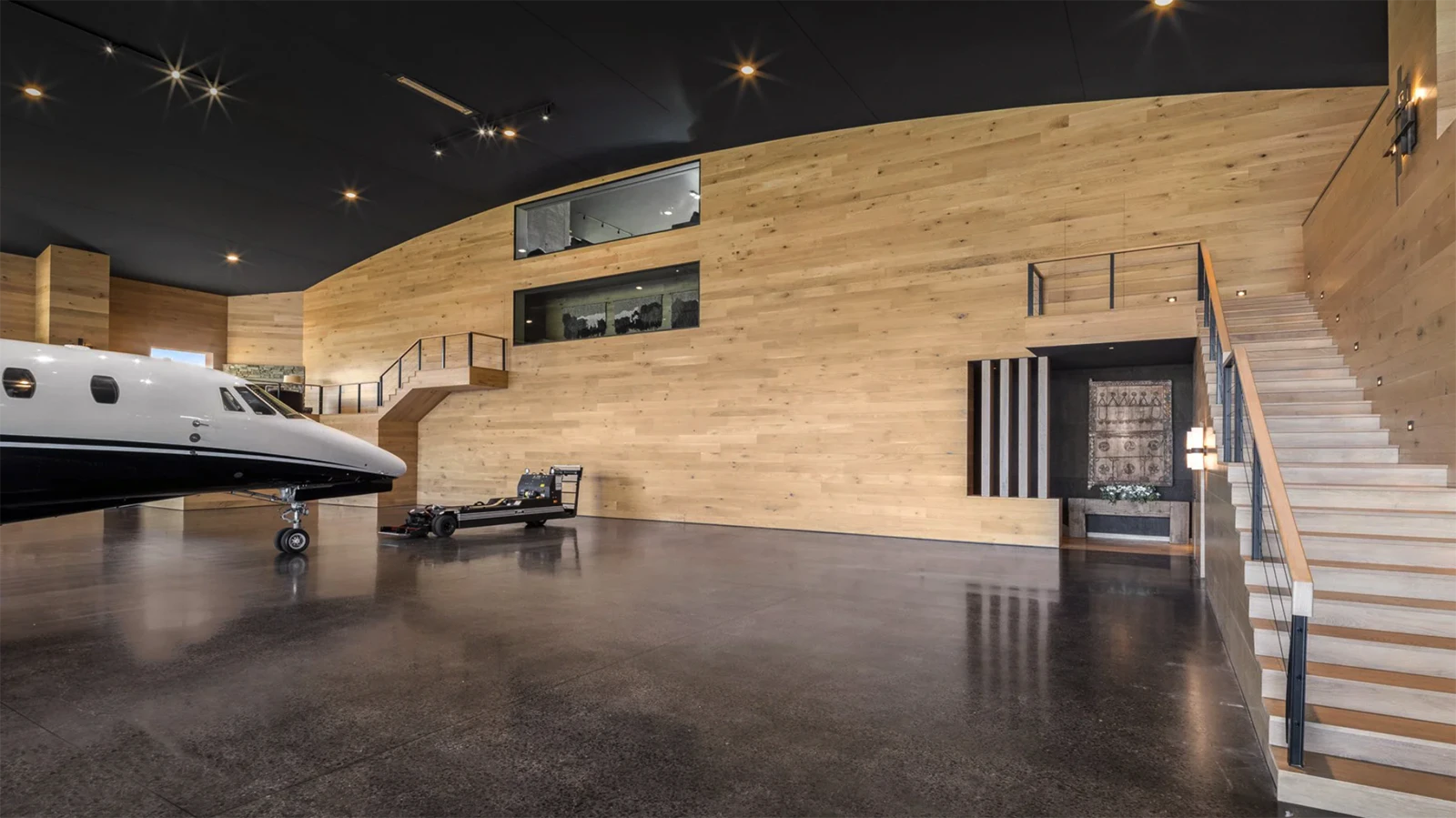 Next to the main residence is a state-of-the-art 9,650-square-foot airplane hanger with a direct taxiway to a runway. The hangar's mezzanine level is a unique space with a stone-clad fireplace and bar area perfect for entertaining.