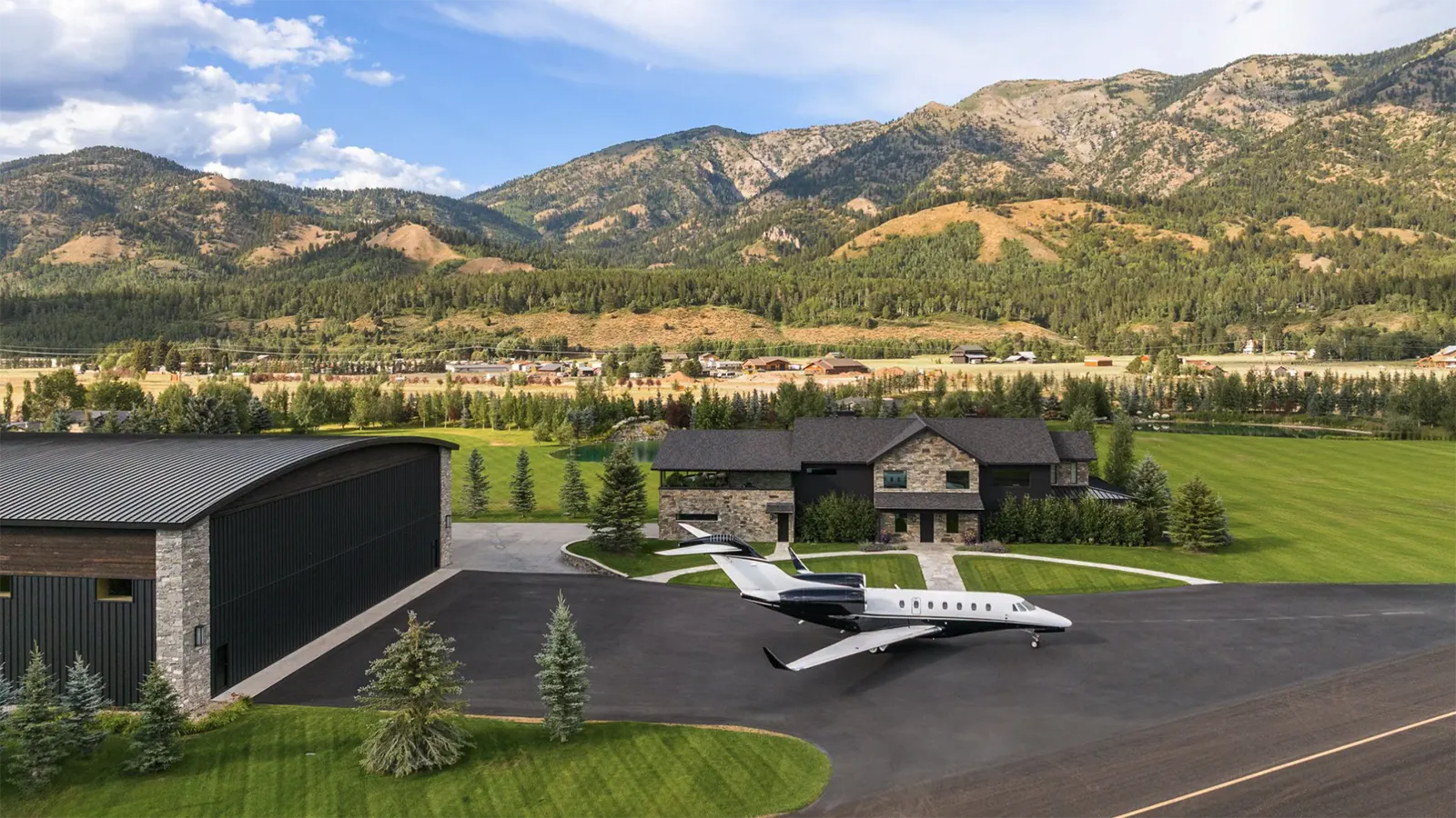 Next to the main residence is a state-of-the-art 9,650-square-foot airplane hanger with a direct taxiway to a runway. The hangar's mezzanine level is a unique space with a stone-clad fireplace and bar area perfect for entertaining.