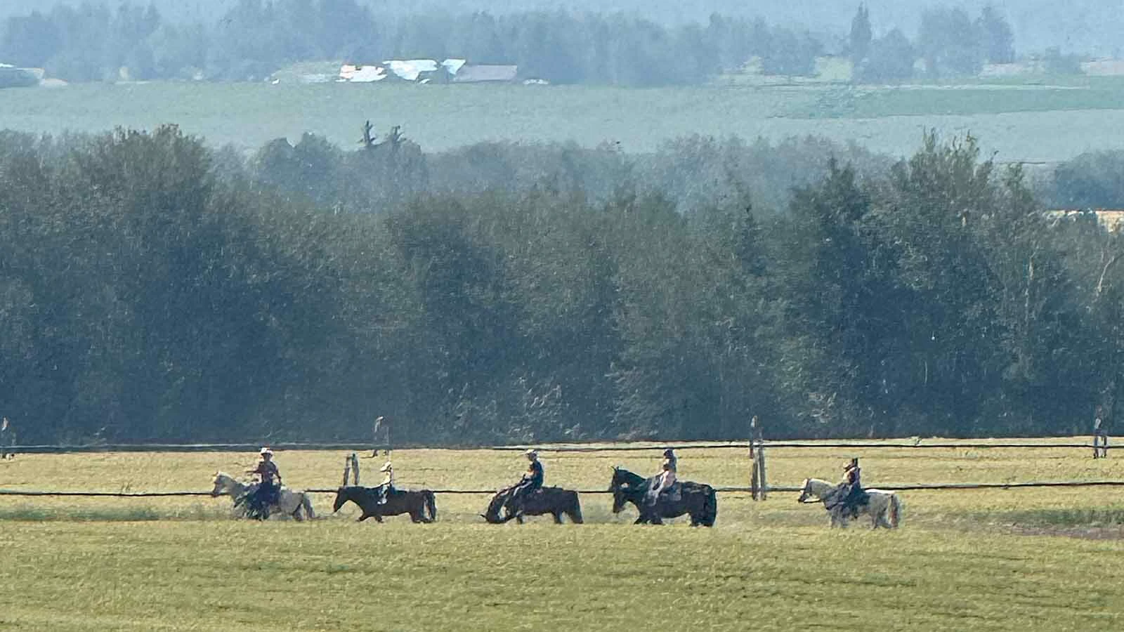 Members of the Rude family ride horses across their Teton County ranch near Alta.