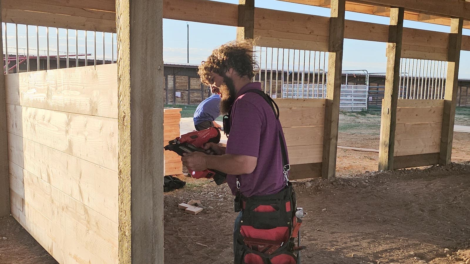 Using a nail gun to tack boards into place.