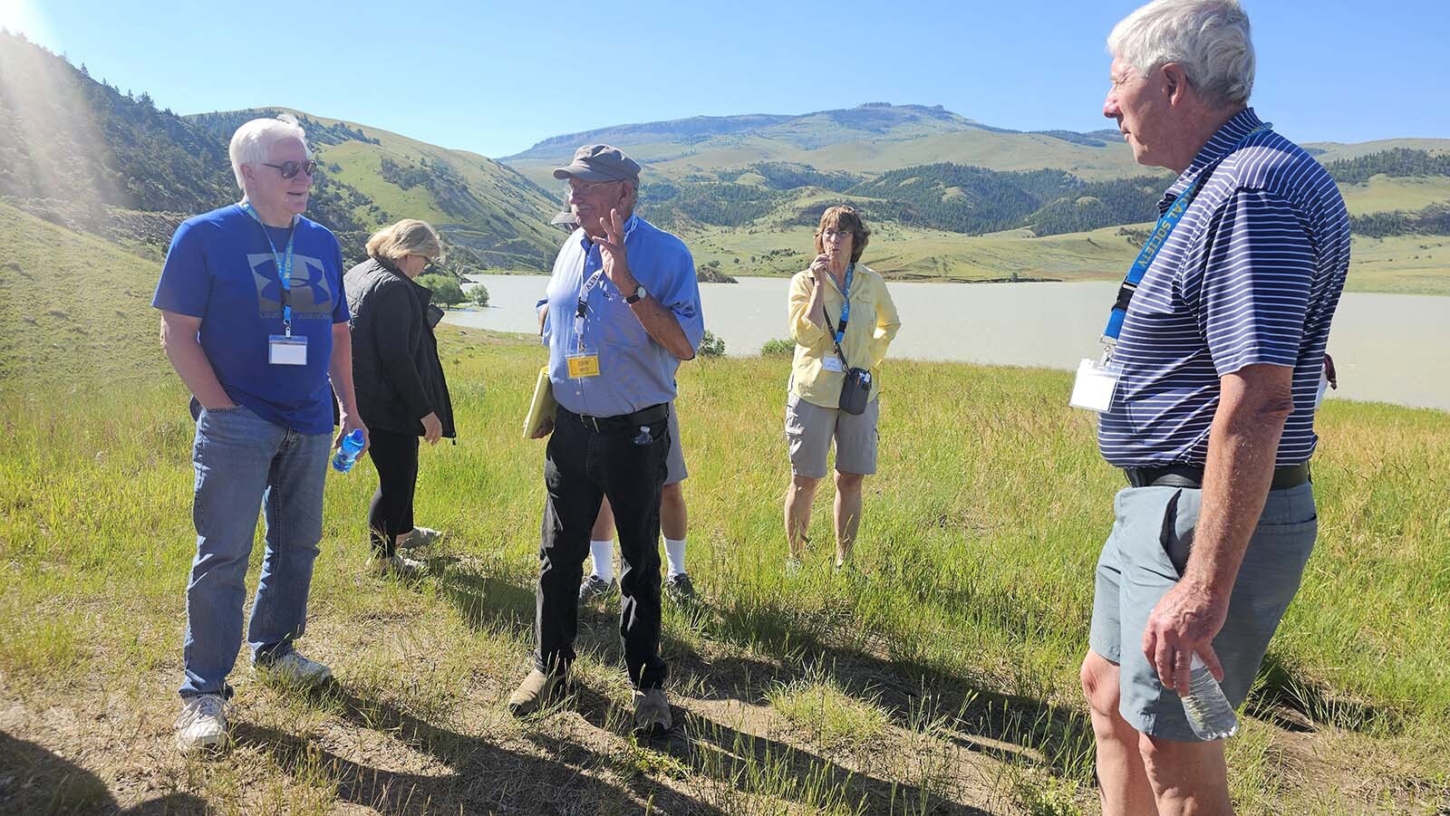 John Vietti, center, talks about Anchor Dam, which is in the background.