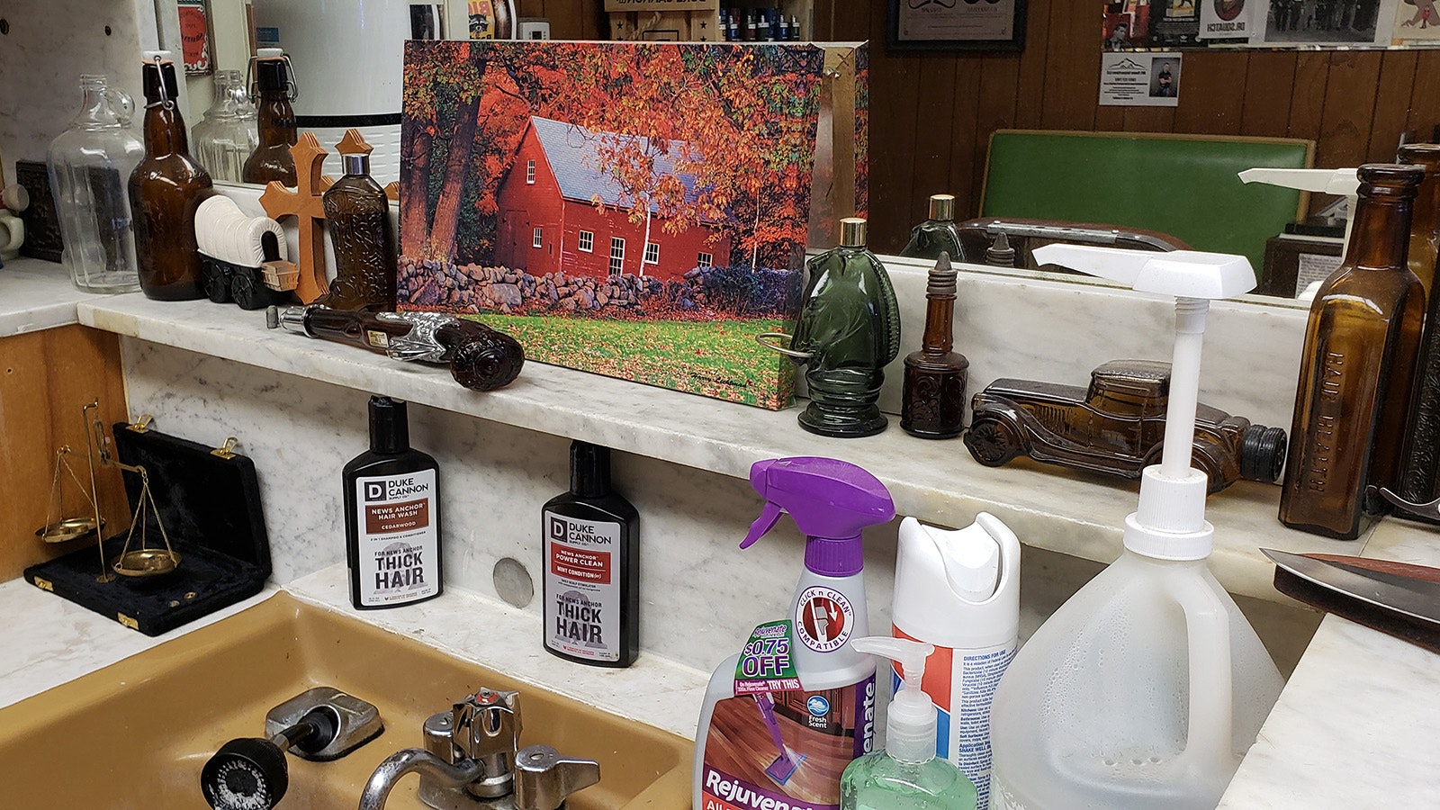 Antique bottles and oil paintings surround the station where Kurt Wheeler washes hair.