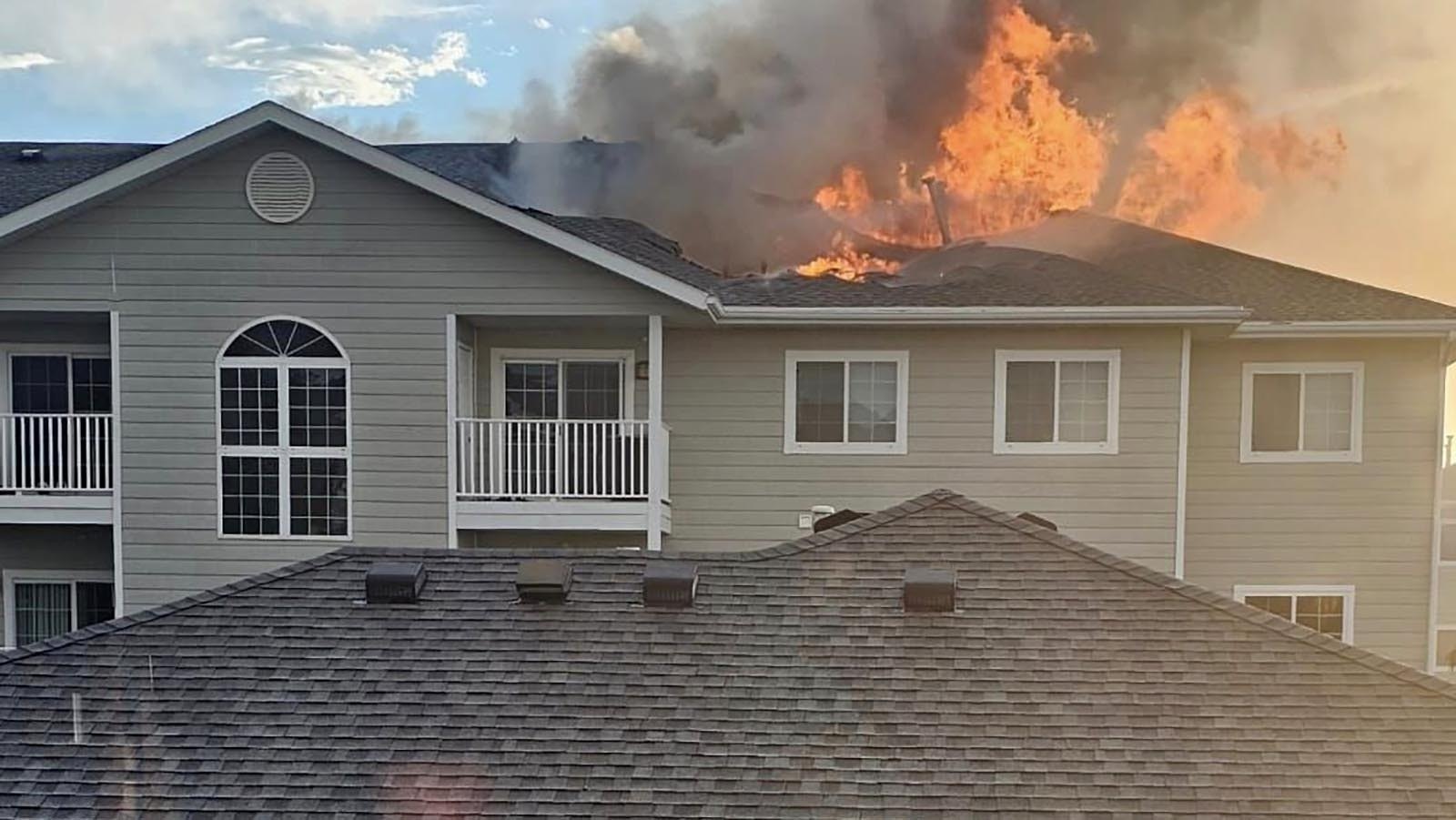 Flames burn through the roof of the Remington Village Apartments in Gillette, Wyoming, on Aug. 6, 2024.