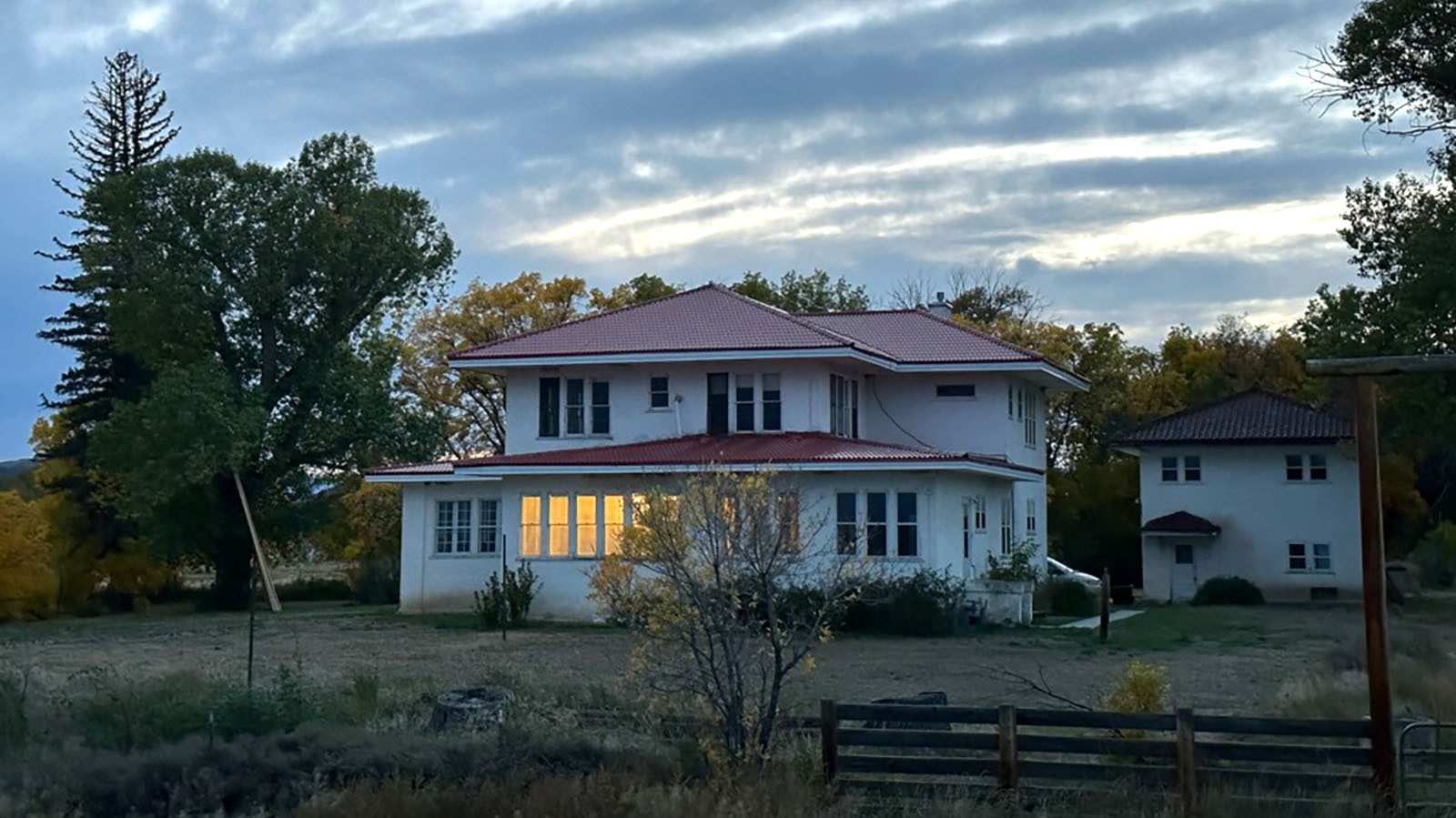The Arapaho Ranch mansion at dusk.
