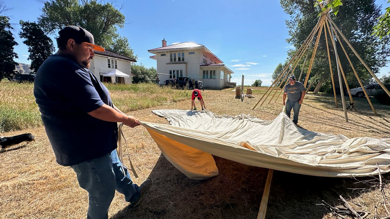 Setting up a tipi outside the Arapaho Ranch mansion.