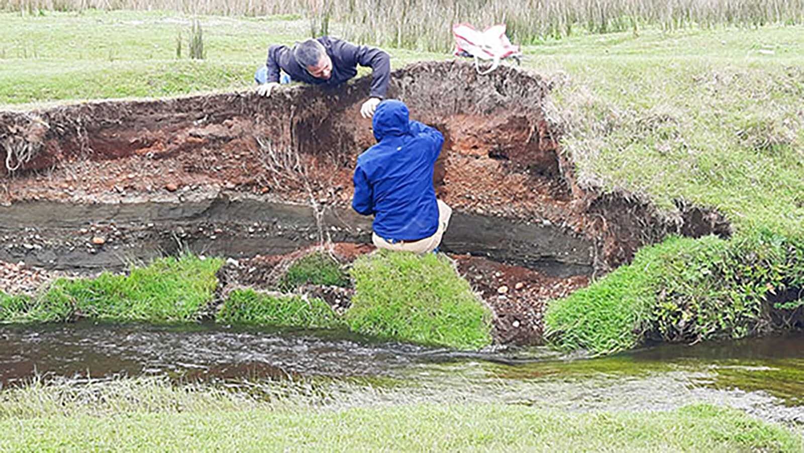 Researchers Todd Surovell and Juan-Luis García examine the bank of the Chinchihuapi Creek near the Monte Verde archaeological site in southern Peru. Their research found that the site is only 4,200-8,200 years old, not 14,500 years old as posited by researchers who worked on the site from the 1970s through the 1990s.