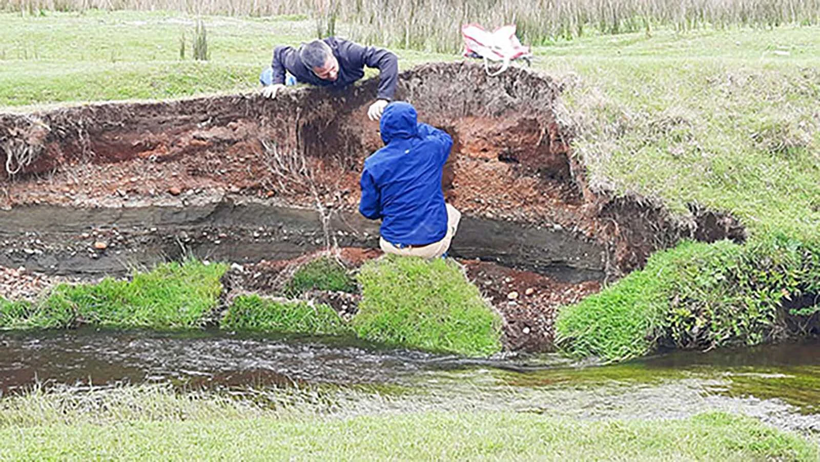 Researchers Todd Surovell and Juan-Luis García examine the bank of the Chinchihuapi Creek near the Monte Verde archaeological site in southern Peru. Their research found that the site is only 4,200-8,200 years old, not 14,500 years old as posited by researchers who worked on the site from the 1970s through the 1990s.
