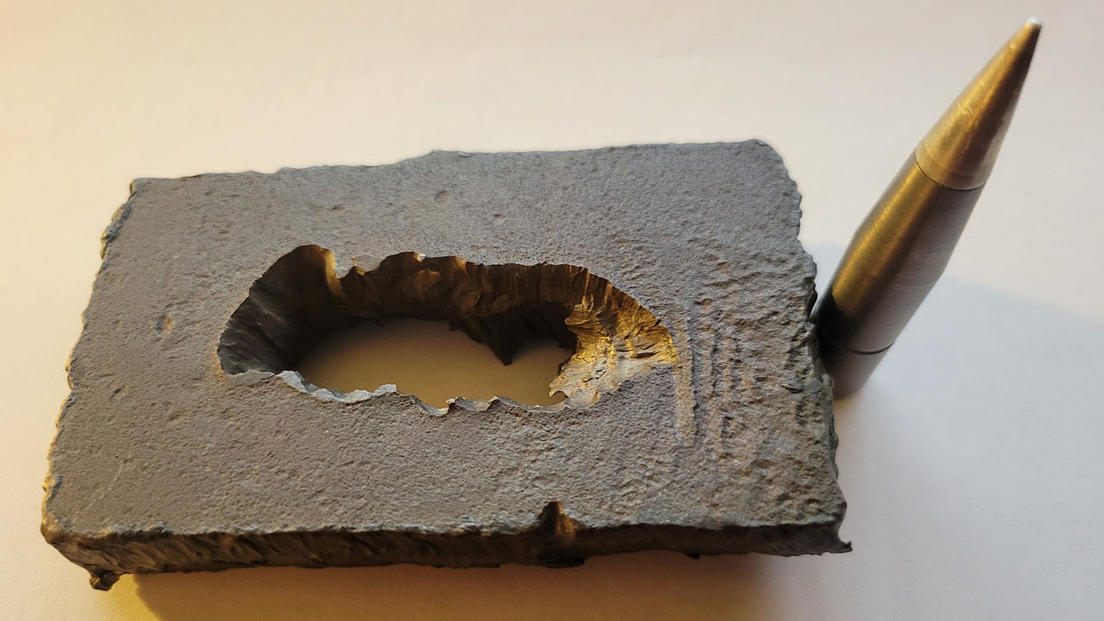 Nothing, not even military-grade armor, is truly “bulletproof.” This is a piece of the frontal armor from a Russian vehicle that was blown through with a 25 mm tungsten sabot round.